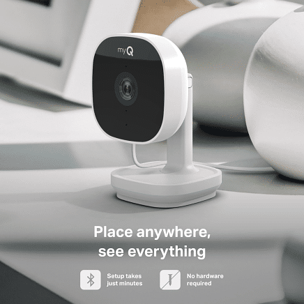 myQ indoor security camera placed on white shelf in modern home